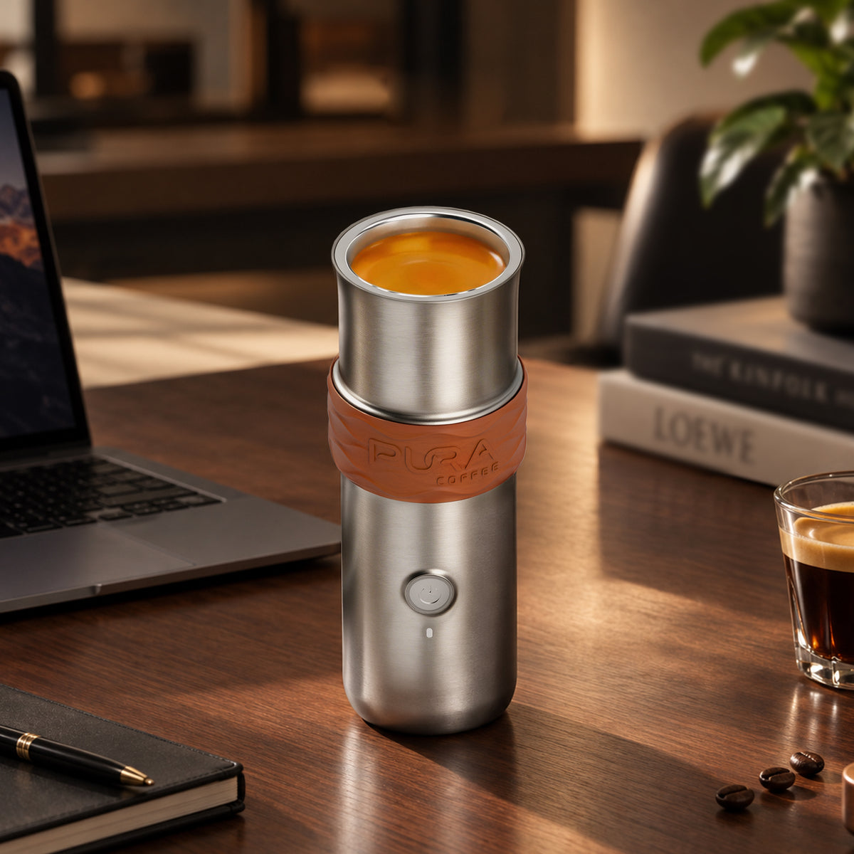 PURA NEO Pro portable espresso machine on a desk beside a laptop, fresh espresso in the drinking cup