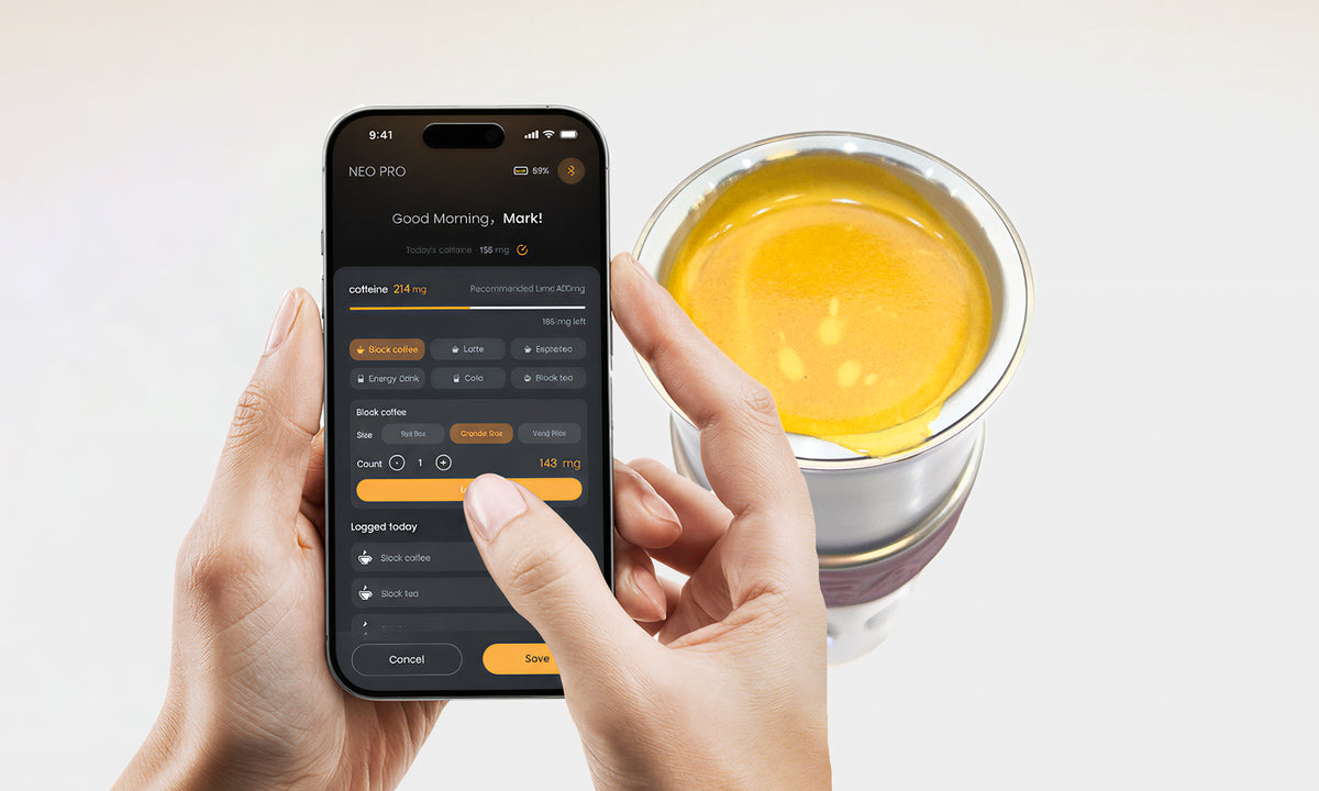 Brew OS app caffeine tracking screen beside a cup of fresh espresso